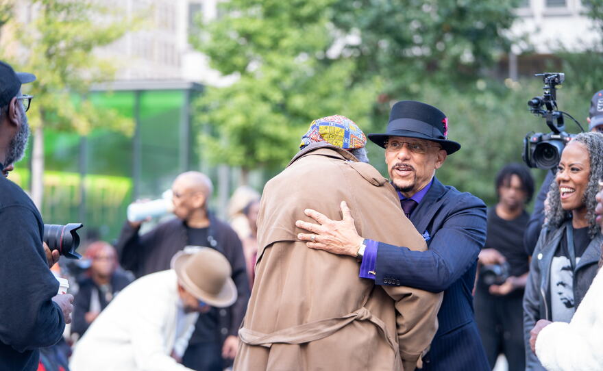 Pennsylvania State Senator Vincent Hughes embraces a fellow John Coltrane enthusiast at A Love Park Supreme.