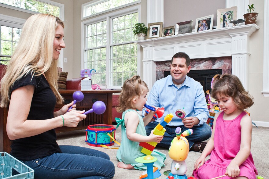 Larry and Carolyn Bloomstein play with their daughters Aria, 2, (left) and Hailey, 5, at home in New Jersey.