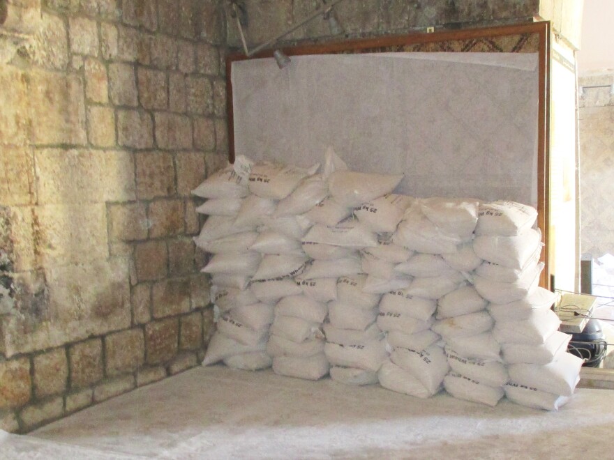 Sandbags are  stacked on the inside walls of the Ma'arra museum, shielding fragile, ancient mosaics from the blast of regime jets and looters.