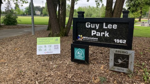 A city park. A sign reads "Guy Lee Park." There are trees in the background. 
