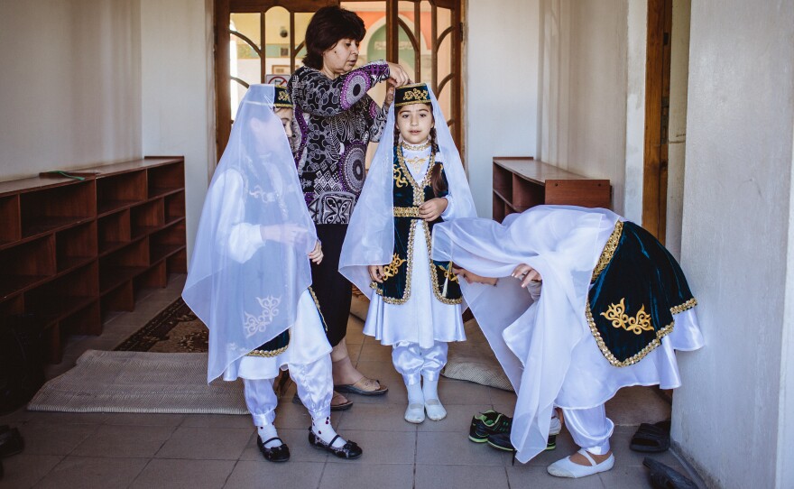 Young girls dressed in traditional Tatar outfits celebrate the Muslim holiday of Eid al-Adha.