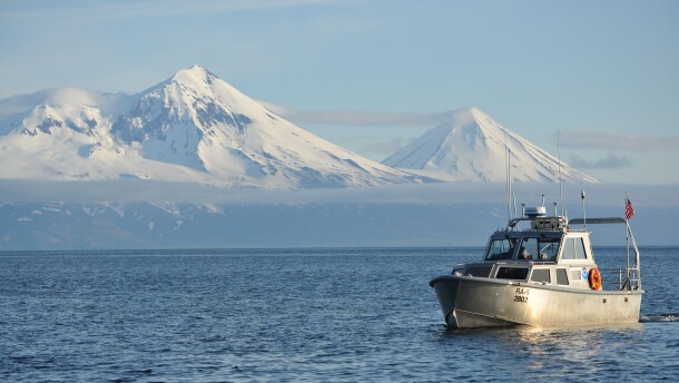 A small launch boat conducts a hydrographic survey off the coast of Alaska