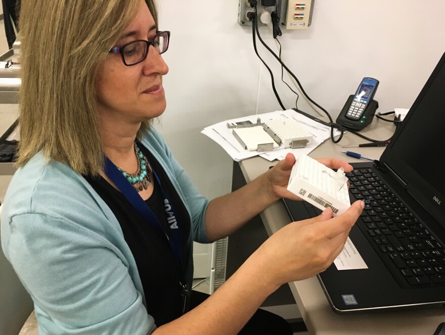 Mine Cicek, an assistant professor at the Mayo Clinic, processes samples for the All of Us program.