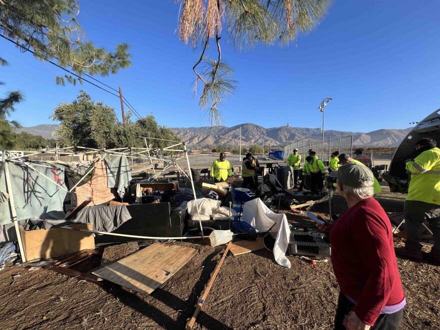 Workers with Burrtec Waste Management dismantling an encampment at Wildwood Park during a sweep on December 5, 2024.