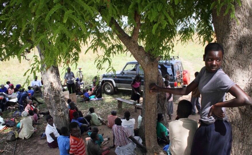 Parents and children gather at the outreach site in Pader. Twice a week, staff from the Atanga Health Center travel to various outreach sites to consult with parents and distribute a month's supply of sodium valproate.