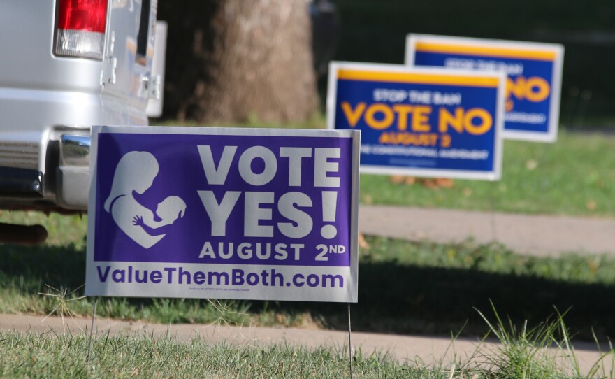 Political signs for the state constitutional amendment vote on abortion rights in Kansas sit near each other in yards in Overland Park, Kan., July 16, 2022.