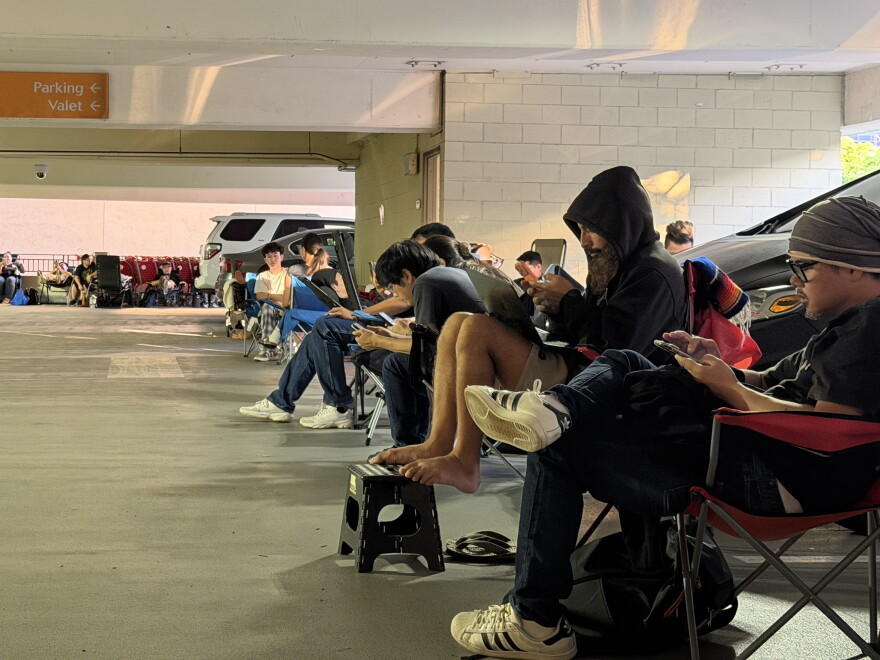 Shoppers wait in the parking structure of the Ala Moana Shopping Center for the Pokémon TCG: 30th Celebration card pack on the morning of Sept. 16, 2026.
