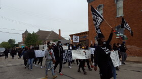 Demonstrators marching down Carroll St on their way to Chandler Park
