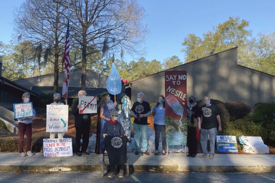 Protesters with signs along a road