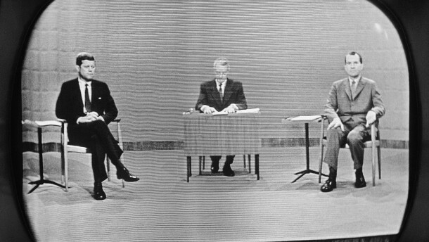 FILE - In this Sept. 26, 1960 file photo, moderator Howard K. Smith sits between, Sen. John Kennedy, left, and Vice President Richard Nixon as they appear on television studio monitor set during their debate in Chicago. (AP Photo)