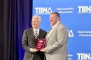 KETR's Jerrod Knight (right) accepts an award plaque from Texas Association of Broadcasters president Oscar Rodriguez (left) at the Texas Broadcast News Awards banquet and ceremony on April 11, 2026 at the Westin Austin at the Domain.