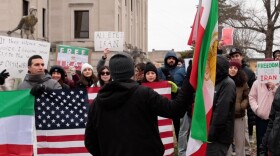 Demonstrators hold flags for the U.S. and Iran at a Jan. 11, 2026, rally at the Monroe County Courthouse. Demonstrators wanted to show support for the people of Iran after thousands were killed in nationwide protests against the Islamic regime.