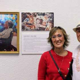 Virginia Kelly and Jimmy Yap stand in front of a display featuring their late mother, Lourdes Navarro, at the Juneau Arts and Culture Center in Juneau on May 1, 2026.