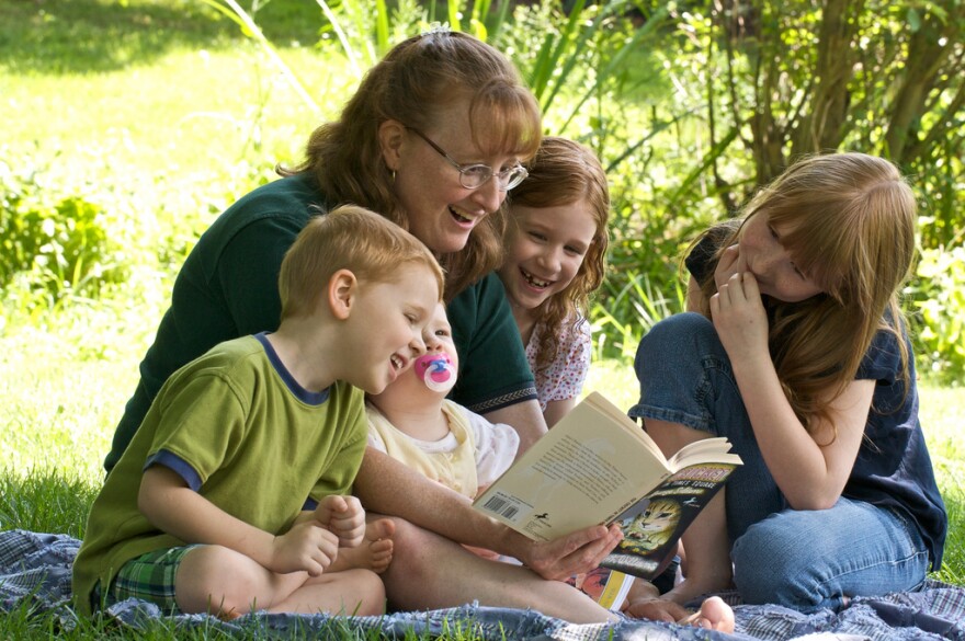 A picture of a family reading together.