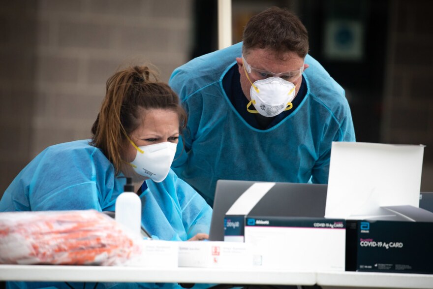 Nomi Health staff members work at a pop-up COVID-19 testing site at the Long Center for the Performing Arts in Austin on Dec. 27.