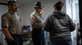 Coos County Sheriff Craig Zanni, center, speaks with Sheriff Department dispatchers on June 6, 2019, in Coquille, Ore. CREDIT: JONATHAN LEVINSON/OPB