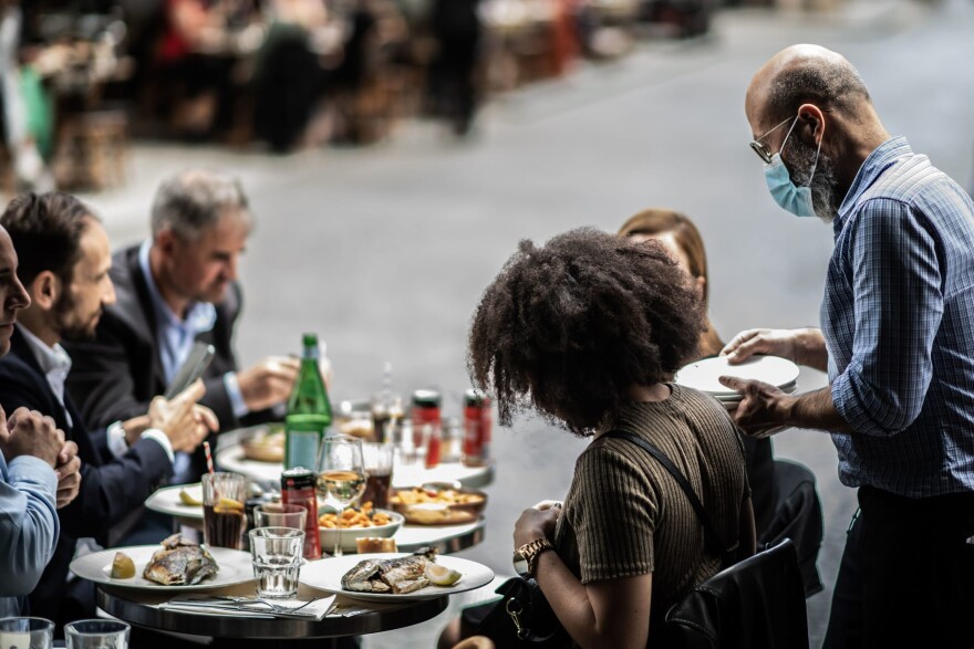 Service workers are on the front lines of COVID-19 — bagging groceries, serving and delivering food — making them more vulnerable to contracting the virus. (Martin Bureau/AFP via Getty Images)