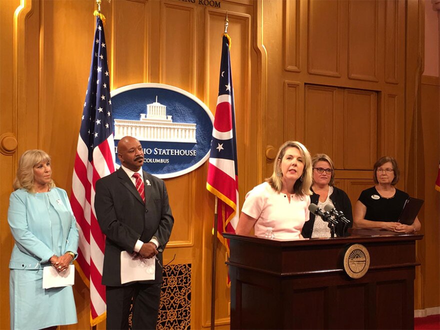 Rep. Allison Russo (D-Upper Arlington) speaks about a proposal calling for more women in leadership positions and is joined by Rep. Sara Carruthers (R-Hamilton), left, and Rep. Thomas West (D-Canton), second from the left.