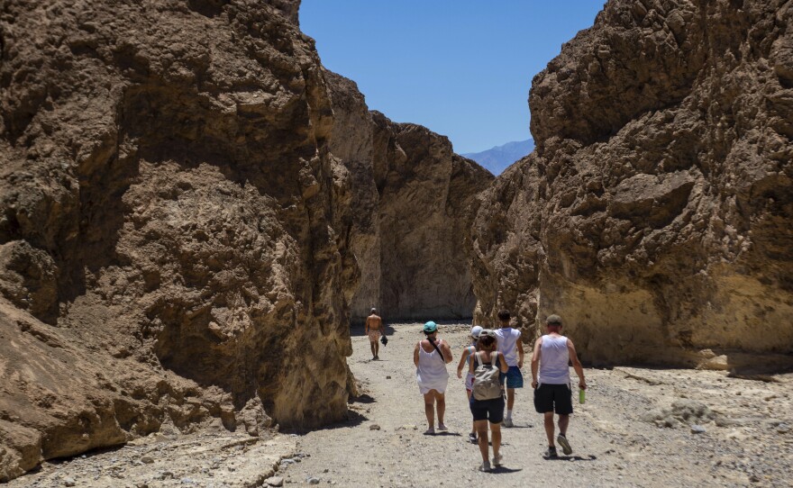 Visitors on Tuesday, July 11, 2023, in Death Valley National Park, Calif.