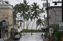A man crosses the road as Hurricane Nolo sits nearby Saturday, Sept. 26, 2026, in Hilo, Hawaiʻi.