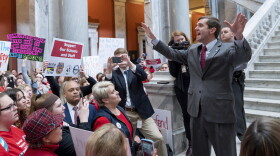 Kentucky Attorney General Andy Beshear speaks to a group of several hundred teachers and their supporters gathered to protest perceived attacks on public education at the Capitol, in Frankfort, Ky, Tuesday, March 12, 2019.