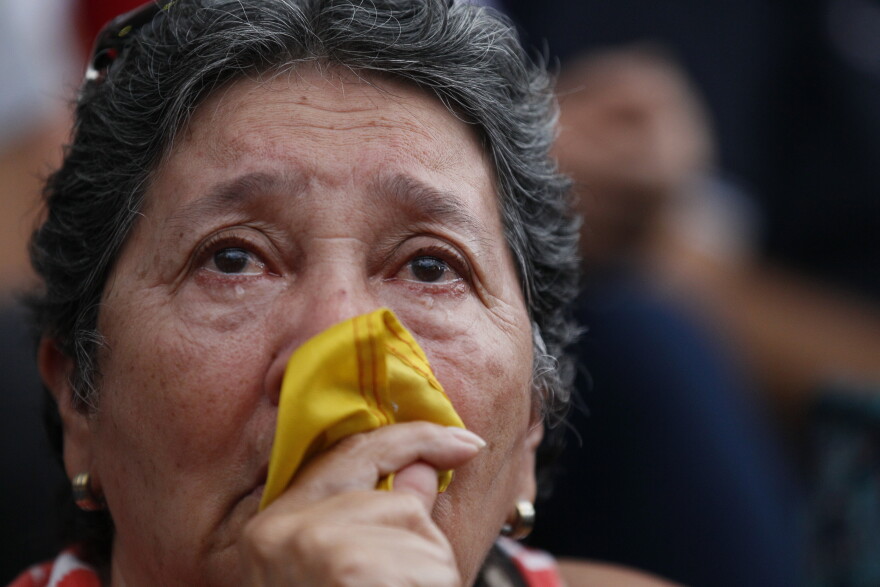 An anti-government demonstrator cries during a vigil in honor of those who have been killed during clashes between security forces and demonstrators in Caracas, Venezuela, Monday, July 31, 2017.