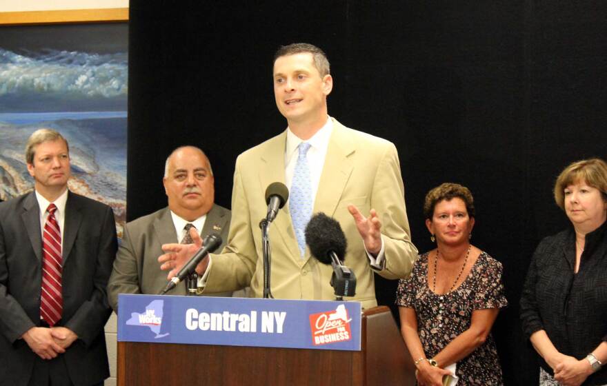 Despite their dramatic difference in height, co-chairs Rob Simpson (center) and Nancy Cantor (to his right) say they're on the same page about the competitiveness of Central New York's regional council.