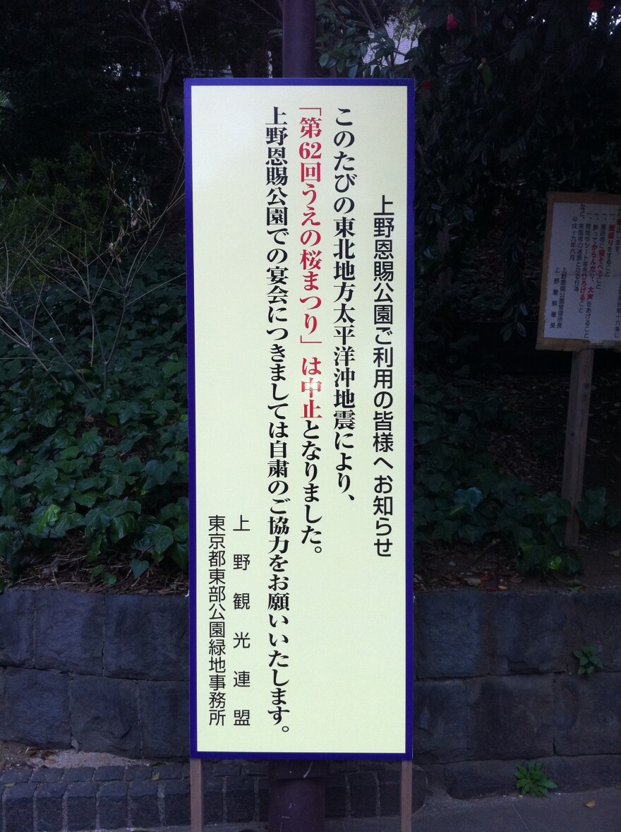 Signs in Tokyo's parks advise visitors not to picnic under the cherry blossoms, as is the national custom at this time of year, out of respect for victims of the earthquake and tsunami.