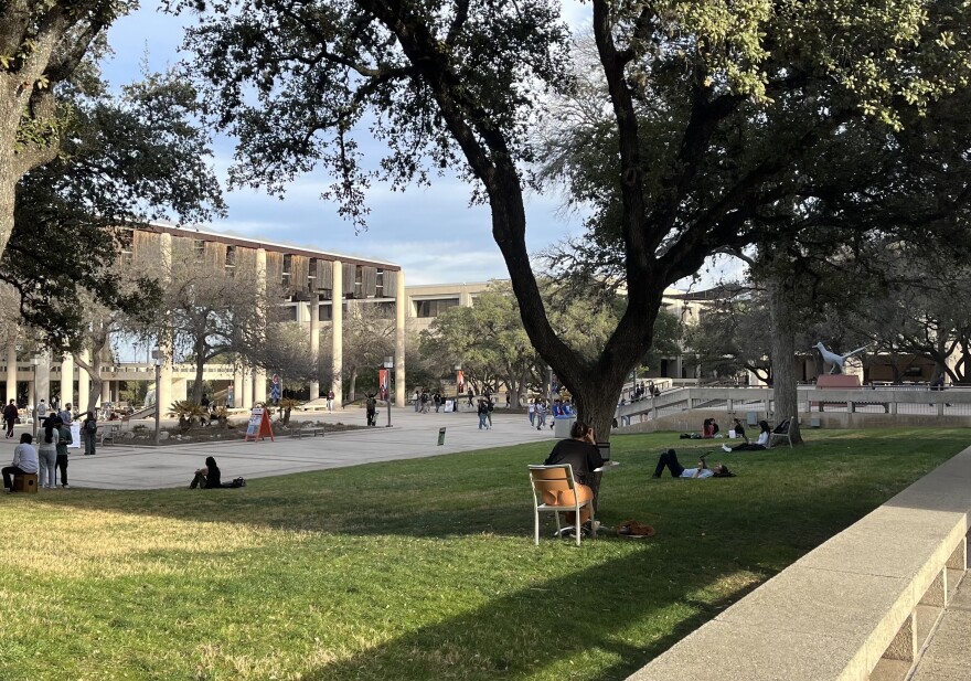 Students sit under live oak trees and study on the main campus of the University of Texas at San Antonio in late February 2026.