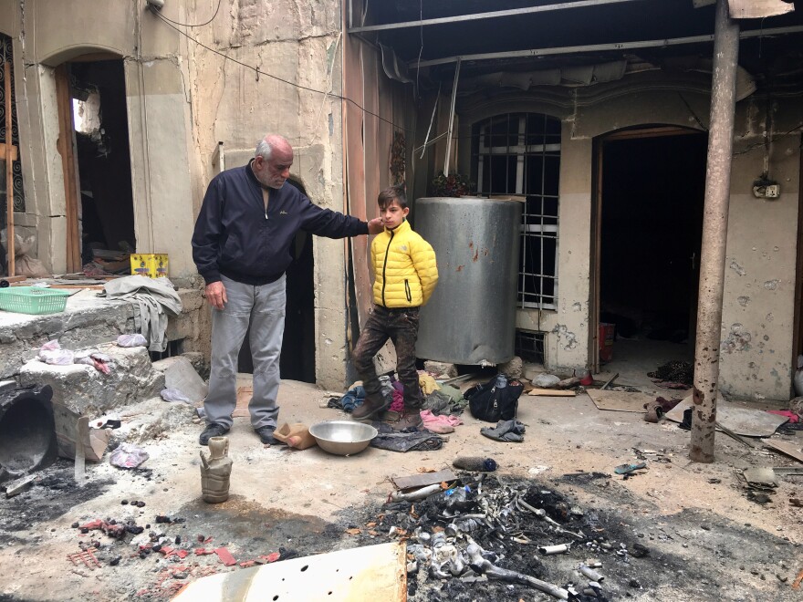 Ziad Abdul Qader and his son Mohammad, 11, came back to their damaged home in the Mosul's Old City. They found ISIS fighters' corpses inside. Abdul Qader owned a clothing store before ISIS. He says Mohammad has panic attacks and has forgotten how to read and write.