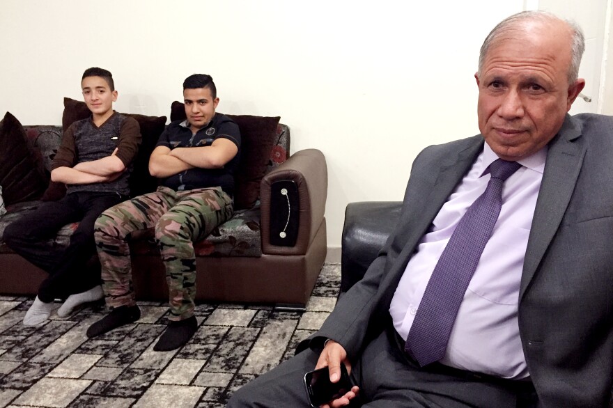Al-Shargat Mayor Ali Dodah Khalaf Jabouri sits with Hani Abdul Karem Jabouri and Sabri Ahmed Jabouri. Each lost family members who were killed by Islamic State fighters, and all are now working with Iran-backed Shiite groups to retake their city.