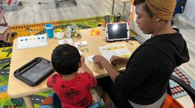 Dayshia Bean, registered behavioral technician at LOGAN'S Riverside autism services center, provides applied behavior analysis to a 3-year-old boy. LOGAN is worried that proposed state funding cuts will reduce the number of kids on Medicaid who receive the therapy.