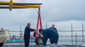Workers for Fleet Readiness Center Mid-Atlantic install equipment on the USS Truman. Oct. 22, 2023. (Department of Defense)