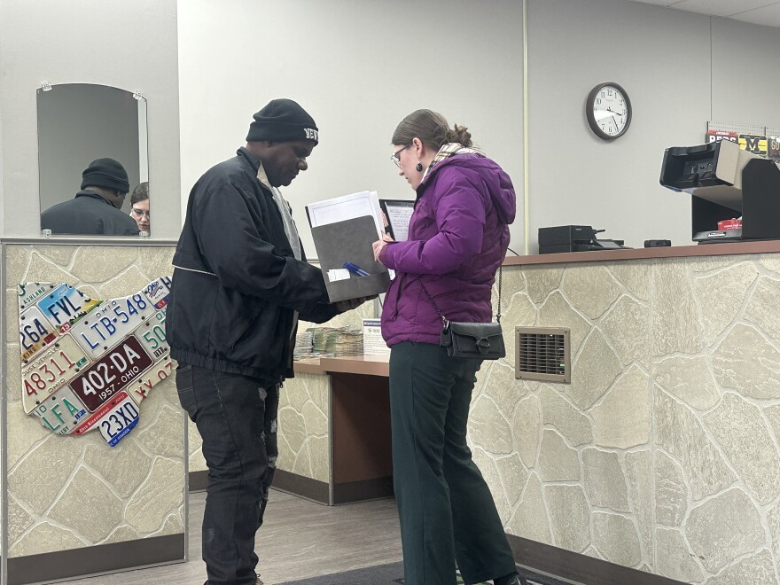 Louis reapplies for a new Ohio driver's license at the Bureau of Motor Vehicles on Bechtle Avenue in Springfield. In 2021, he fled dangerous gangs in Haiti and moved to the city. ABLE attorney Brandy Keesee assists him with paperwork.