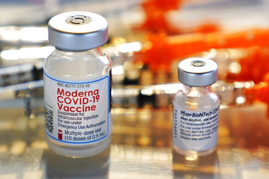 FILE - This Thursday, Feb. 25, 2021 file photo shows vials for the Moderna and Pfizer COVID-19 vaccines at a temporary clinic in Exeter, N.H.
