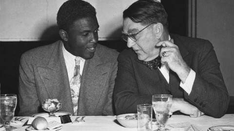Brooklyn Dodgers' president Branch Rickey, right, and the team's star rookie Jackie Robinson, confer at the Chicago Baseball Writers' Association annual dinner in Chicago, Ill., Jan. 18, 1948.