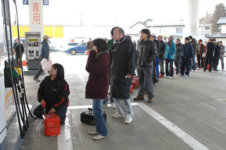 People in Sendai lining up for fuel at an operating gas station.