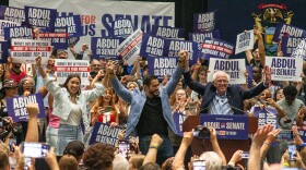 U.S. Senate candidate Abdul El-Sayed on stage with Bernie Sanders and Alexandria Ocasio-Cortez during a campaign rally at the Lansing Convention Center on July 19, 2026.