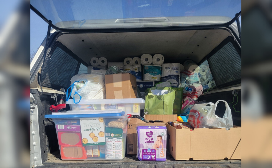 A truck is loaded with paper supplies like diapers and toilet paper as well as non-perishable food items to deliver to those in need.