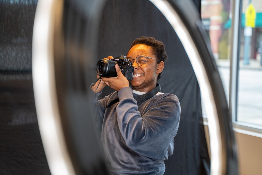 One of Bridget Caswell's proteges, 18-year-old Dawn Moss frames his camera for pictures with one of the subjects for the Still, We Believe project.