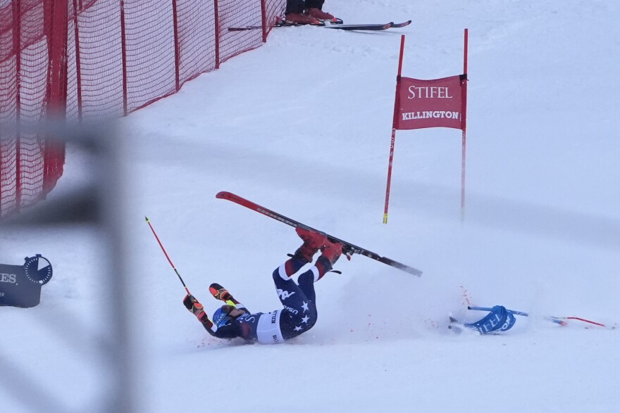 A skier lands on snow on her back