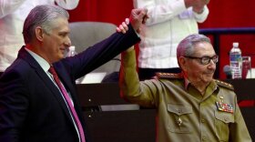  Outgoing Cuban Communist Party First Secretary Raul Castro (right) presents his replacement, Cuban President Miguel Diaz-Canel at the close of the party's 8th Congress in Havana on Monday.