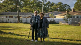 Photo by Kristen Zeis. John and Gloria Creekmur stand in the front yard of what was once their house. The Creekmurs built the home in 1968 and moved out in 2012 as part of Chesapeake’s program that buys properties that frequently flood.