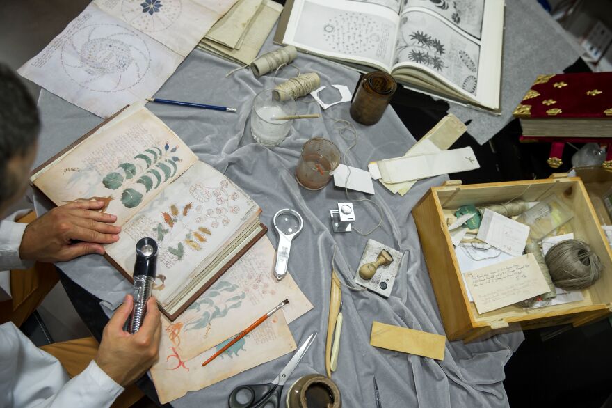 Luis Miguel, a quality control operator with Siloe, works on cloning the illustrated,hand-written Voynich Manuscript in Burgos, Spain, on Aug. 9.