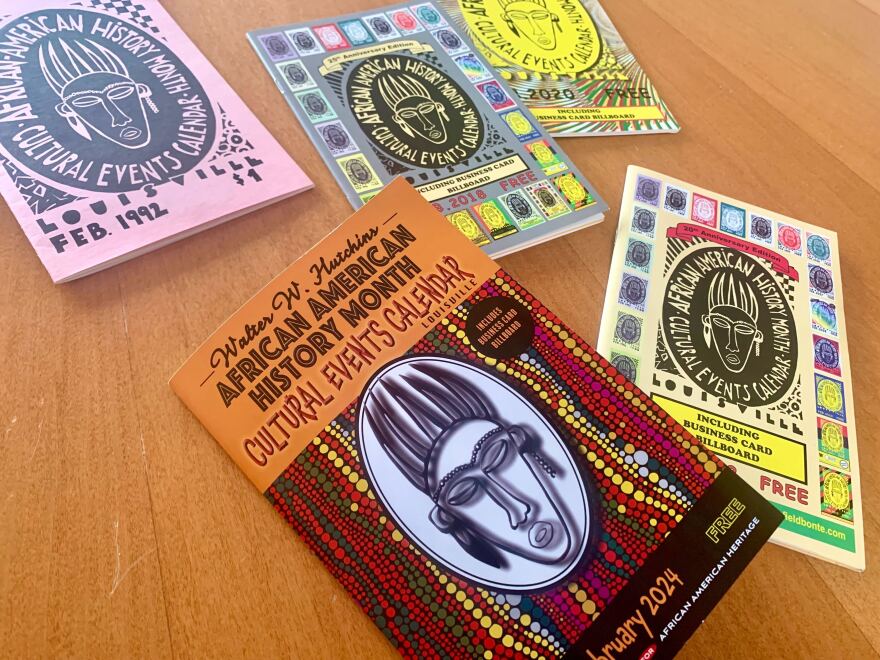 Five copies of colorful booklets featuring a similar image of an African mask scattered across a table.