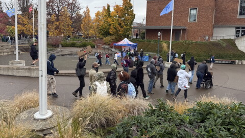 A group of protesters march into the EMU Amphitheater at the University of Oregon to protest the Turning Point USA debate event with Alex Stein, Oct. 28, 2026.