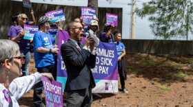 Daniel Tucker, a leader with the Missouri Workers Center, teaches chants customized to an initiative petition to raise the minimum wage and mandate paid sick leave on Wednesday, May 1, 2024, outside of the Secretary of State's office building in Jefferson City.