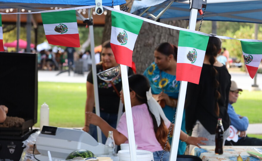 Mexican flags decorated the vendor booths at the 5th Annual Hispanic Heritage Celebration put on by SALSA at Riverside Park. Photo by Allison Diaz.
