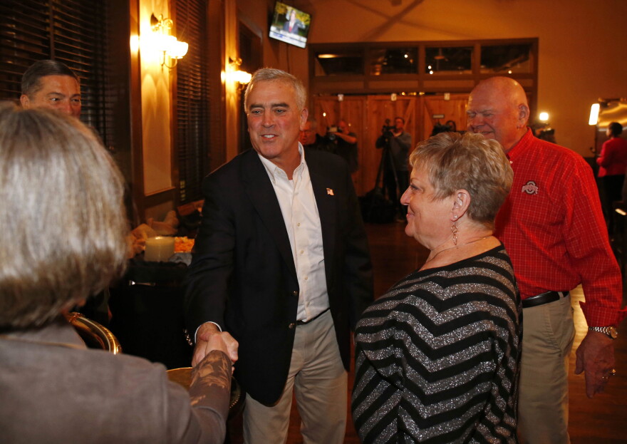 Rep. Brad Wenstrup, R-Ohio, center, greets supporters during an election night watch party Tuesday, Nov. 6, 2018, in Cincinnati.