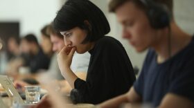 People work at computers in a community space.